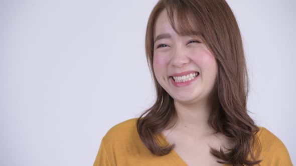 Face of Happy Young Asian Woman Thinking