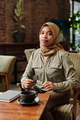 Young successful female employee or intern in hijab sitting in armchair - PhotoDune Item for Sale
