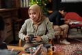 Young Muslim female employee with cup of herbal tea looking at colleague - PhotoDune Item for Sale