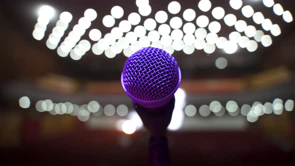 Close Up View of Microphone on Stage Facing Empty Auditorium in Big Concert Hall