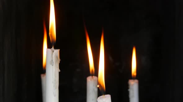 Long White Wax Church Hot Candles on a Black Background