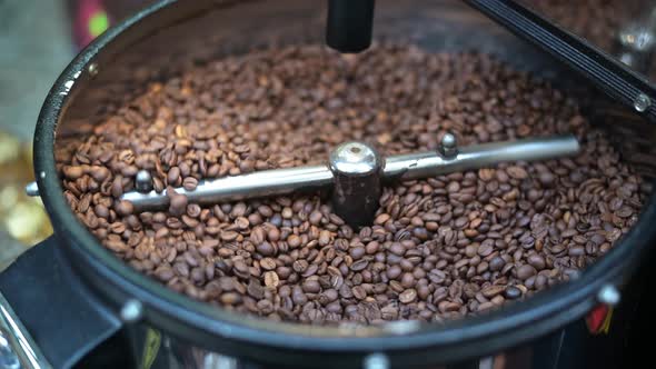 Mixing and Roasting Brown Coffee Beans on Cooling Plate - Professional Coffee Roaster Machine During