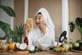 Happy asian woman holding bowl applying white mask homemade moisturizing and nourishing face mask - PhotoDune Item for Sale