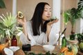 Young asian woman holding avocado and making homemade cream for healthy skin. - PhotoDune Item for Sale