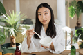 Beautiful healthy asian woman mixing the mass in a bowl while preparing cream. - PhotoDune Item for Sale