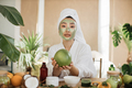 Portrait of beautiful young asian woman with green cosmetic mask on face holding pomelo - PhotoDune Item for Sale