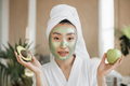 Portrait of beautiful young asian woman with green cosmetic mask apple and avocado in her hands - PhotoDune Item for Sale