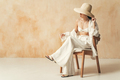Rich asian woman in hat and beach clothes resting on chair - PhotoDune Item for Sale