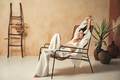 Korean woman in pajama and bra resting on lounger with closed eyes, stretching hands up after nap - PhotoDune Item for Sale