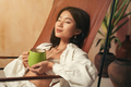 Close-up of korean woman having rest after work enjoying relaxing herbal tea and silence - PhotoDune Item for Sale