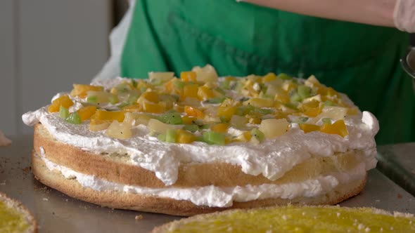 Confectioner Puts Fruits on Cake Layer