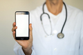 Male doctor in medical coat showing mobile phone with blank white screen - PhotoDune Item for Sale