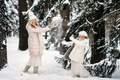 Handsome mother and daughter are having fun outdoor in winter time. Playing with snow in forest  - PhotoDune Item for Sale