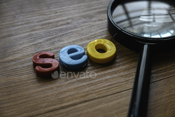 ss and alphabet of seo on a wooden background.