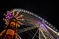 Ferris wheel and merry-go-round illuminated at night - PhotoDune Item for Sale