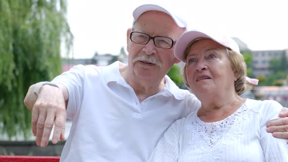 Happy old couple eating ice cream in the park.