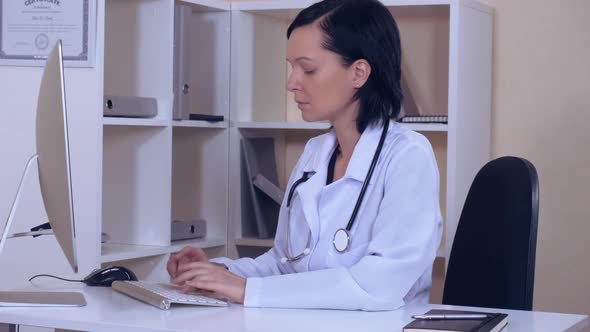 Physician in Clinic Use Computer