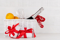 Basket with Christmas gift boxes, champagne, oranges - PhotoDune Item for Sale
