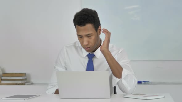 Tired Afro-American Businessman with Neck Pain at Work