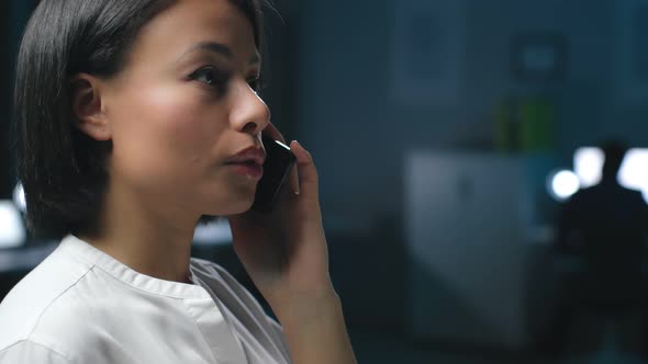 Close Up of AfricanAmerican Businesswoman Having Phone Call Late in Office