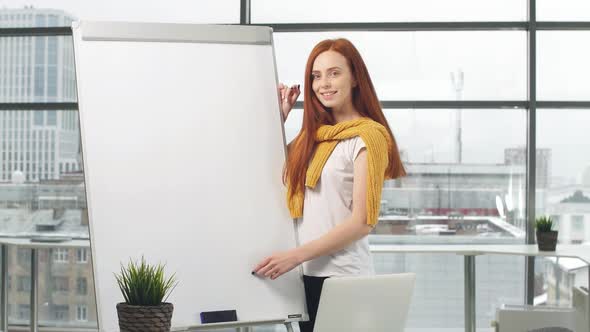 Portrait of Young Redhead Girl in Office Interior