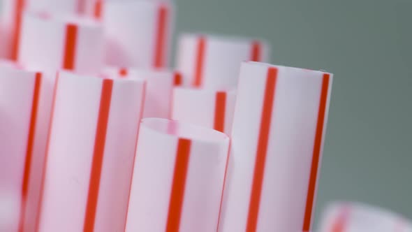 Macro close-up, a bunch of red and white single-use plastic straws