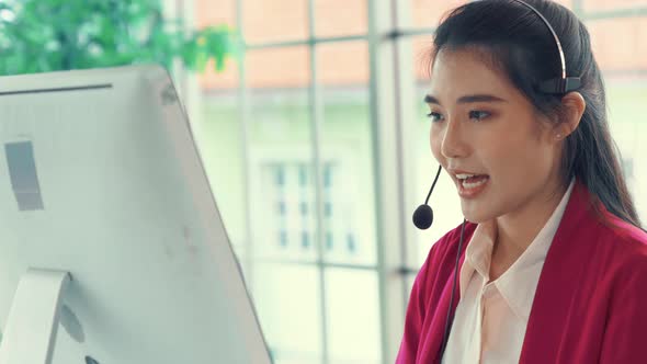 Businesswoman Wearing Headset Working Actively in Office