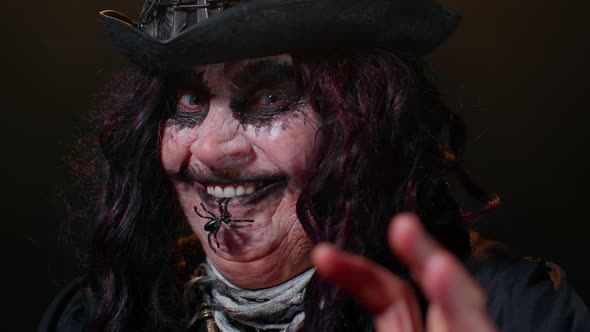 Creepy Scary Mature Woman Grandmother with Halloween Stylish Witch Makeup Making Terribly Faces