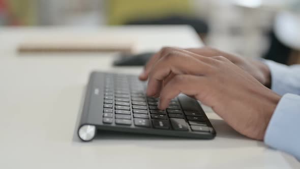 Hands of African Man Using Mouse on Desktop Close Up