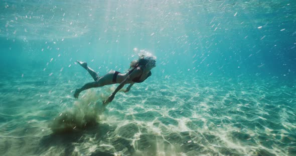 Beautiful woman swimming in underwater paradise