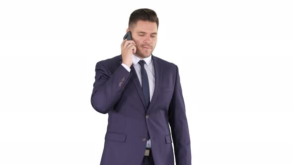 Thoughtful Young Businessman in Suit and Tie Making Several Calls Quickly on White Background.