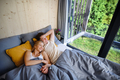 Young happy couple in love lying in bed in morning in their new home in tiny house, sustainable - PhotoDune Item for Sale