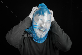 f-asphyxiation concept. Garbage bag on head. Shortness of breath, lack of air. Black background.