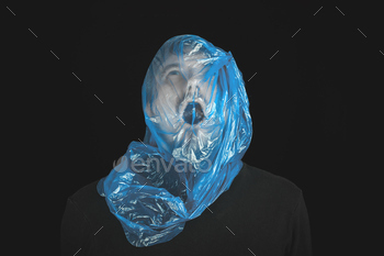 . Self-asphyxiation concept. Suicide bag on man head. Shortness of breath, lack of air. Black background.