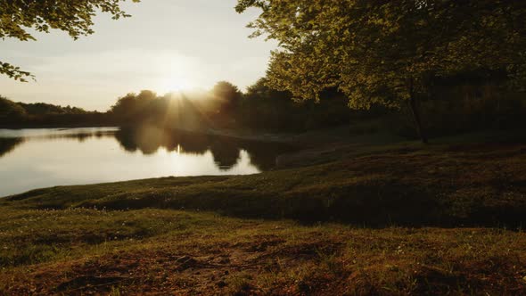 Boy with Mountain Bike By the Lake at Sunset