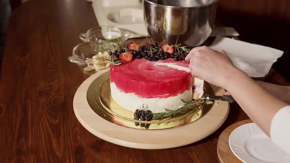 Close Up Shot of a Sweet Cake That a Woman Cuts and Puts a Slice on a Plate