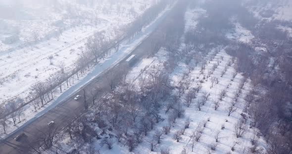 Winter Village and Highway with Cars in the Fog