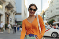 Smiling woman walking through the city - PhotoDune Item for Sale