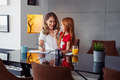 Mother tutoring daughter at home, helping her study for school - PhotoDune Item for Sale