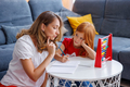 Mother helping daughter with homework - PhotoDune Item for Sale