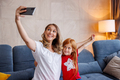 Mother and daughter taking a selfie at home - PhotoDune Item for Sale