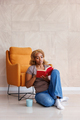 Woman reading a book and drinking coffee at home - PhotoDune Item for Sale