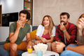 People eating popcorn and watching TV at home - PhotoDune Item for Sale