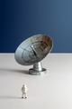 Minimalistic still life astronaut miniature looking at astronomical radio telescope vertical - PhotoDune Item for Sale