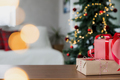 Christmas, New Year background. Empty wooden tabletop with bokeh fir tree, gift - PhotoDune Item for Sale