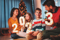Family holding illuminative numbers 2023 while celebrating New Year - PhotoDune Item for Sale