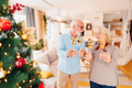 Senior couple holding little balloons shaped as numbers 2023 - PhotoDune Item for Sale