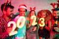 Friends having fun at New Year party, holding illuminative numbers 2023 - PhotoDune Item for Sale