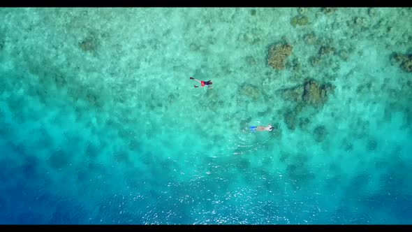 Aerial seascape of marine lagoon beach trip by blue green lagoon with white sand background of a day