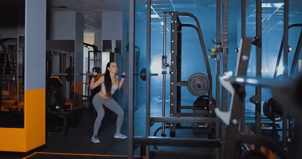 Girl Squats with a Barbell